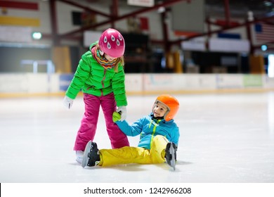 Child Skating On Indoor Ice Rink. Kids Skate. Active Family Sport During Winter Vacation And Cold Season. Little Girl And Boy In Colorful Wear Training Or Learning Ice Skating. School Sport Clubs