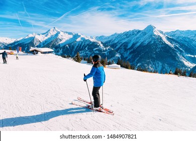 Child Skier Skiing On Ski Resort Penken Park In Tyrol In Mayrhofen In Zillertal Valley In Austria In Winter Alps. Kid Ski Alpine Mountains With White Snow And Blue Sky. Austrian Snowy Slopes.