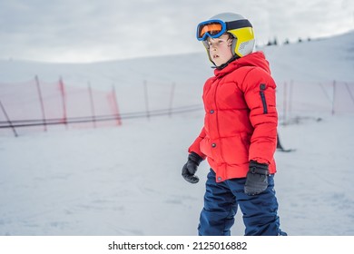 Child skiing in mountains. Active toddler kid with safety helmet, goggles and poles. Ski race for young children. Winter sport for family. Kids ski lesson in alpine school. Little skier racing in snow