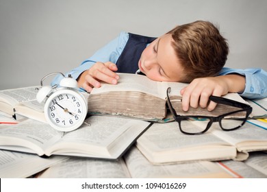 Child Sleep On Books, Tired Student Kid Studying, Face Lying On Book Near Alarm Clock, Children Hard Education Concept