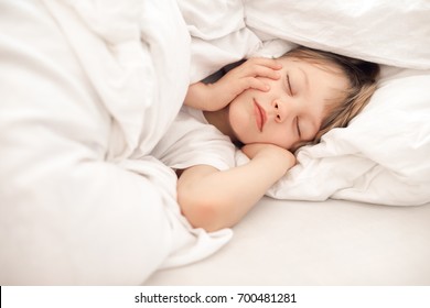 Child Sleeping In Bed