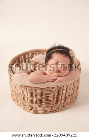 Similar – Baby lying in a wicker basket