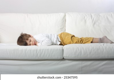 child sleeping on a sofa