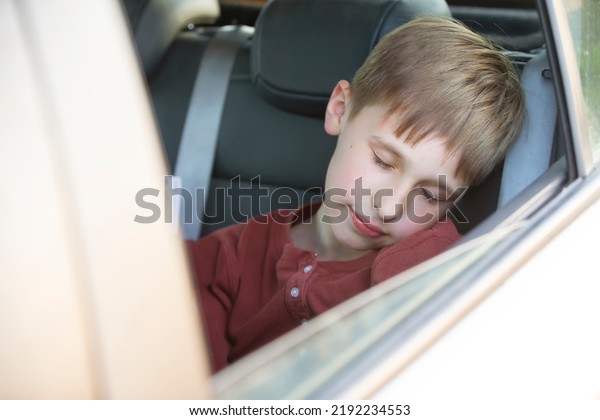 The child sleeps in the car. The little boy
was tired and fell asleep in the
car.