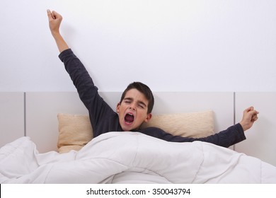 child sleepy yawning in bed - Powered by Shutterstock