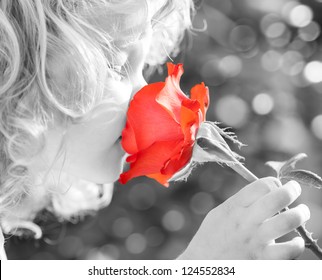 Child Smelling Rose Flower In Spring Outdoors. Monochrome, Color-separation