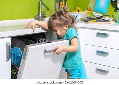 A Child Smells A Dishwasher. Problems With Bad Smell In The Kitchen