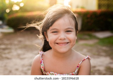 Child Smiling In A Beautiful Sunset