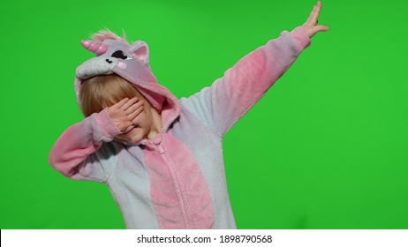 Child smiling, dancing, celebrating, performing dab dance in unicorn costume on chroma key background. Kid girl animator making dabbing movement with hands up, internet meme gesture in unicorn pajamas - Powered by Shutterstock - Get 15% off with code: PIKWIZARD15