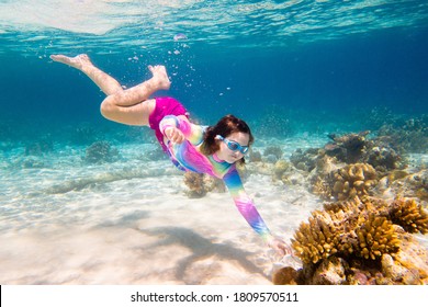 Child Snorkeling. Kids Swim Underwater. Beach And Sea Summer Vacation With Children. Little Girl Watching Coral Reef Fish. Marine Life On Exotic Island. Kid Swimming And Diving With Snorkel And Mask.