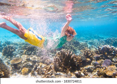 Child Snorkeling. Kids Swim Underwater. Beach And Sea Summer Vacation With Children. Little Boy Watching Coral Reef Fish. Marine Life On Exotic Island. Kid Swimming And Diving With Snorkel And Mask.