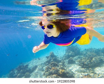 Child Snorkeling. Kids Swim Underwater. Beach And Sea Summer Vacation With Children. Little Girl Watching Coral Reef Fish. Marine Life On Exotic Island. Kid Swimming And Diving With Snorkel And Mask.