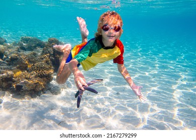 Child Snorkeling. Kids Swim Underwater. Beach And Sea Summer Vacation With Children. Little Boy Watching Coral Reef Fish. Marine Life On Exotic Island. Kid Swimming And Diving With Snorkel And Mask.