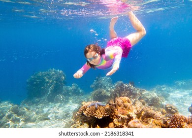 Child Snorkeling. Kids Swim Underwater. Beach And Sea Summer Vacation With Children. Little Girl Watching Coral Reef Fish. Marine Life On Exotic Island. Kid Swimming And Diving With Snorkel And Mask.