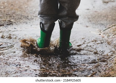 Child Splashing In A Muddy Puddle