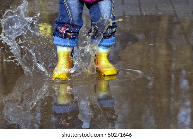 Child Splashing In Puddle