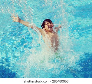 Child Splashing In Summer Water Pool