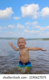 Child Splashing Water In The River