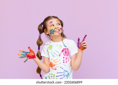 A child stained in multicolored paints will have to be creative. The concept of children's creativity on a pink isolated background. - Powered by Shutterstock