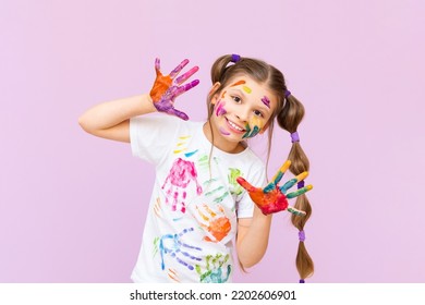 A child stained in multicolored paints will have to be creative. The concept of children's creativity on a pink isolated background. - Powered by Shutterstock