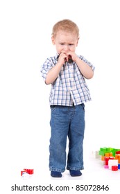 Child Standing Crying, Near Toys Over White Background