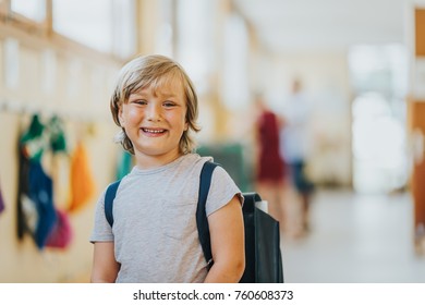 Child Standing In School Hallway, Wearing Old Vintage Back Pack.