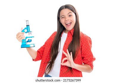Child study bilogy lesson. Teenage school girl with microscope. Back to school. Girl scientist isolated on white. Portrait of emotional amazed excited teen girl