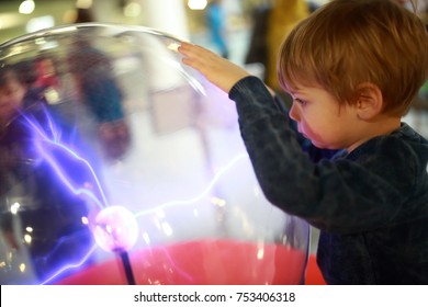 Child Studying Electrical Discharges In A Lab