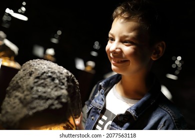 Child Studying Natural Mineral In Geological Museum