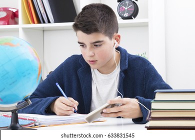 Child Studying And Writing On The Desktop