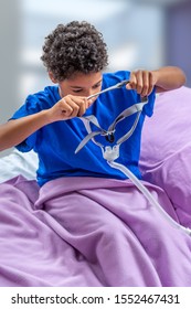 Child Suffering From Sleep Apnea, Using A CPAP Machine