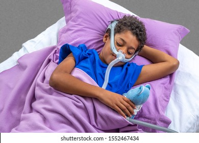 Child Suffering From Sleep Apnea, Using A CPAP Machine