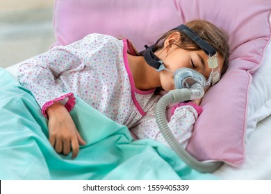 Child Suffering From Sleep Apnea, Using A CPAP Machine