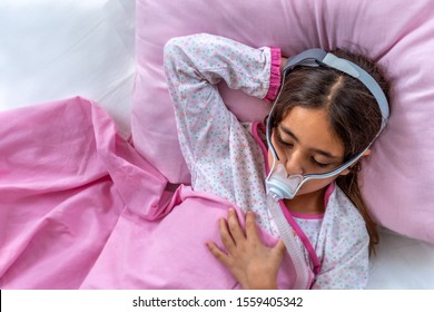 Child Suffering From Sleep Apnea, Using A CPAP Machine