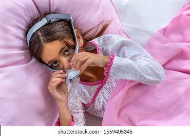 Child Suffering From Sleep Apnea, Using A CPAP Machine