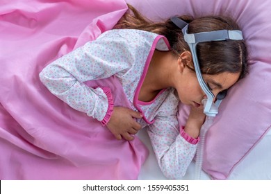 Child Suffering From Sleep Apnea, Using A CPAP Machine