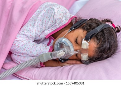 Child Suffering From Sleep Apnea, Using A CPAP Machine