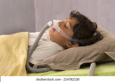 Child Suffering From Sleep Apnea, Using A CPAP Machine