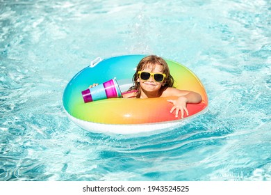 Child summer vacation. Kid boy swimming in pool. Having fun at aquapark. Funny kid on inflatable rubber circle. Summertime. Attractions concept