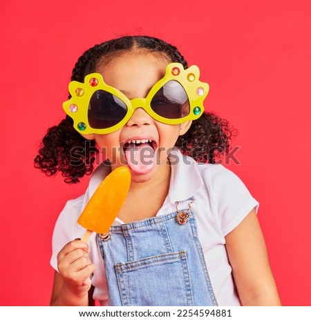 Child, sunglasses or ice cream on isolated red background or tongue, cool or summer fashion clothes. Happy, kid or girl with lolly, cold sweet or funny glasses for sun protection during fun vacation