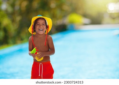 Child with sunscreen at swimming pool. Sunblock for healthy tan. Safe fun in summer time. Kids play. UV protection and skin care. Little boy on beach vacation. Family holiday. Sun burn prevention. - Powered by Shutterstock