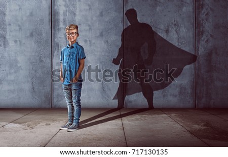 Child with superhero shadow