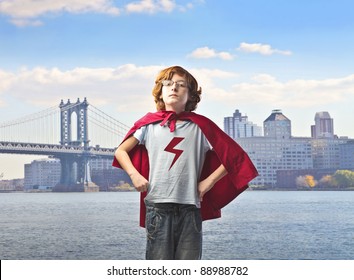 Child In Superhero Suit With Cityscape In The Background