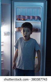 Child Surprised At Night To Sneak In A Refrigerator