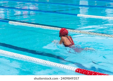 child swimmer swim in swimming pool. Water sports and competition, learning to swim classes for children. - Powered by Shutterstock