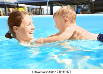 Child Swimming Lesson. Cute Little Boy Learning To Swim With Mother In Pool