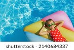 Child in swimming pool. Having fun on vacation at the hotel pool. Colorful vacation concept.