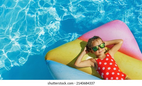 Child in swimming pool. Having fun on vacation at the hotel pool. Colorful vacation concept. - Shutterstock ID 2140684337