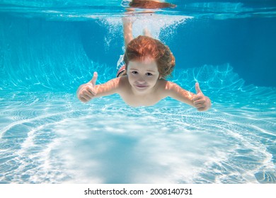 Child Swimming Underwater With Thumbs Up. Underwater Kid Swim Under Water. Child Boy Swimming And Diving Underwater In Pool. Summer Family Summer Vacation With Children. Underwater Kids Activity.