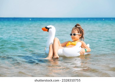 The child swims in a circle in the sea. Selective focus. Kid. - Shutterstock ID 2328310755